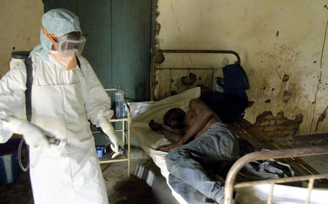 an agent of the congolese red cross disinfecting a room of the kelle hospital northwestern congo where an ebola fever infected patient lies photo afp