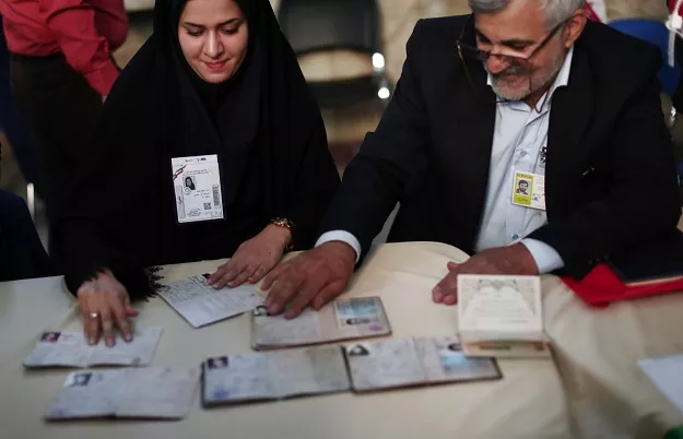 election officials check people 039 s id cards at a polling station in tehran on may 19 2017 photo afp election officials check people 039 s id cards at a polling station in tehran on may 19 2017 photo afp