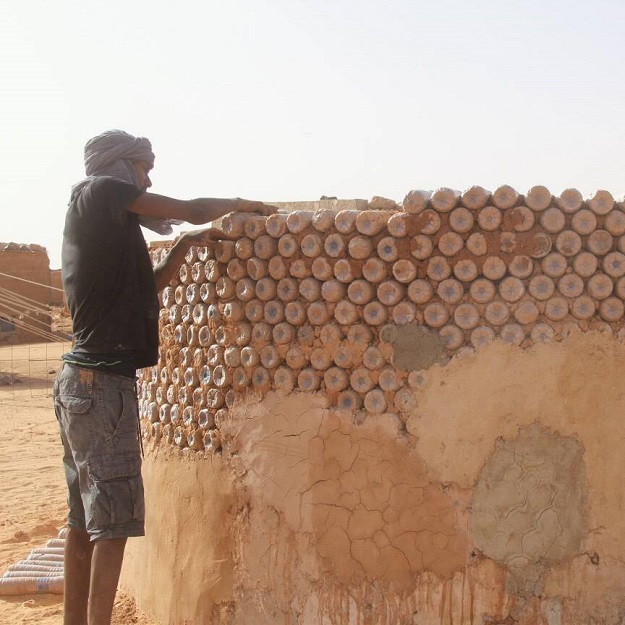 breica is using plastic bottles to build homes for other refugees living in the desert camp photo facebook