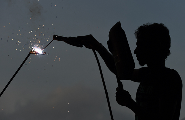 a sri lankan ironworker welds material at a building site in colombo photo reuters