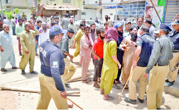 swift action policemen trying to disperse the crowd who tried to block sindh building control authority s demolition of illegal floors in commercial buildings of hyderabad photo online