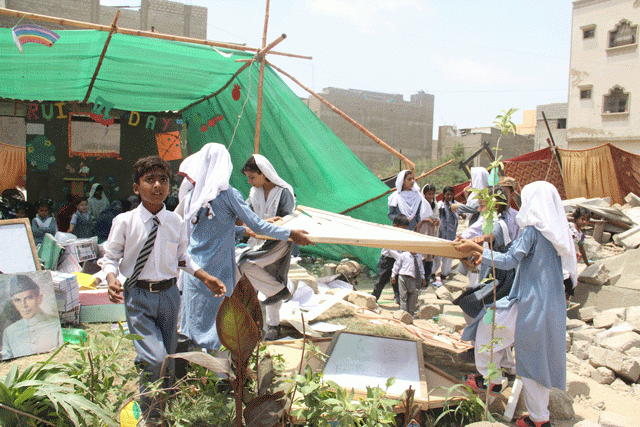 students sift through the rubble to collect their books copies chairs and blackboards photo ayesha mir students sift through the rubble to collect their books copies chairs and blackboards photo ayesha mir