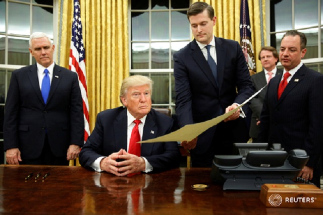 white house staff secretary rob porter 2nd r gives president donald trump flanked by vice president mike pence and chief of staff reince priebus the document to confirming james mattis his secretary of defense his first signing in the oval photo reuters