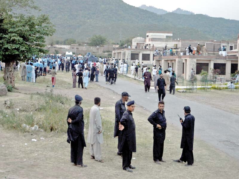 police backed by armoured personnel carriers are present at qau photo mudassar raja express