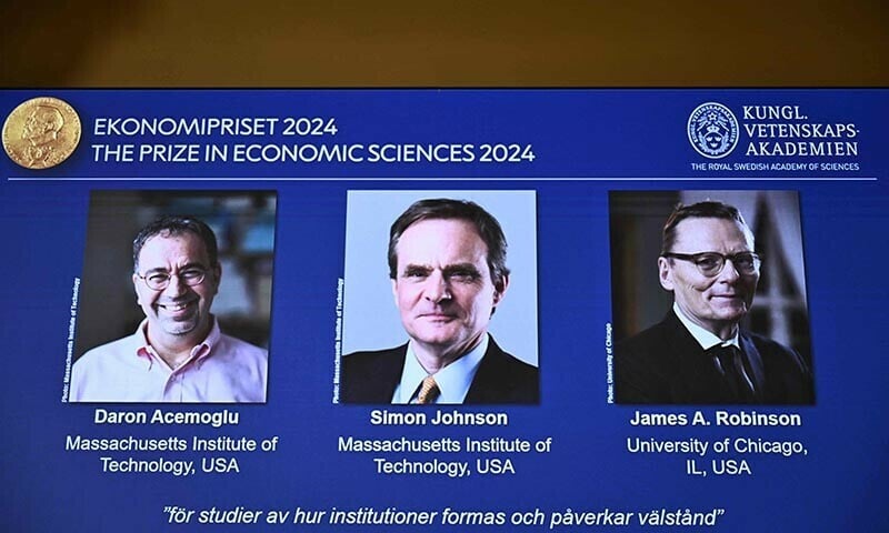 a screen shows the laureates l r turkish american daron acemoglu and british americans simon johnson and james robinson of the 2024 sveriges riksbank prize in economic sciences in memory of alfred nobel during the announcement by the royal swedish academy of sciences in stockholm sweden on october 14 2024 photo afp