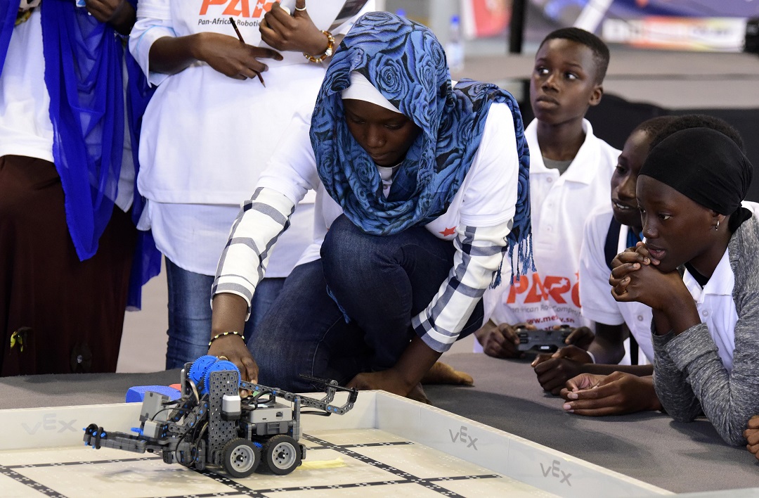 a competitor prepares a robot during the final of the national robotics competition on may 20 2017 at the marius ndaye stadium in the senegalese capital dakar photo afp