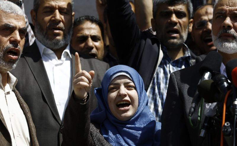 the widow of hamas 039 killed military commander mazen faqha speaks alongside the group leader ismail haniya in gaza city on may 11 2017 photo afp