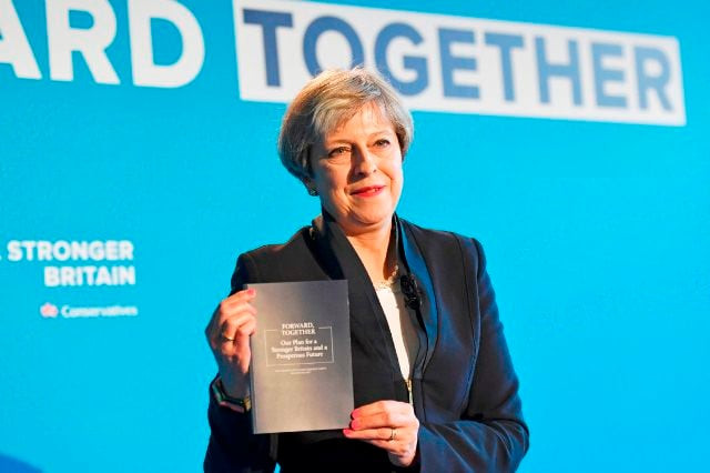 britain 039 s prime minister theresa may holds up the conservative party general election manifesto as she speaks at the launch event in halifax in northern england photo afp britain 039 s prime minister theresa may holds up the conservative party general election manifesto as she speaks at the launch event in halifax in northern england photo afp