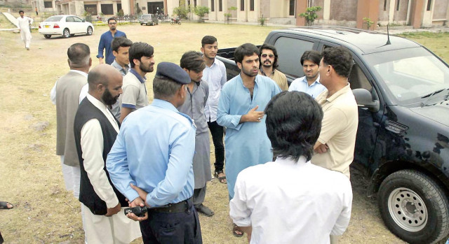 security officials talk to students at qau during investigation of saturday s riot on the campus photo online security officials talk to students at qau during investigation of saturday s riot on the campus photo online