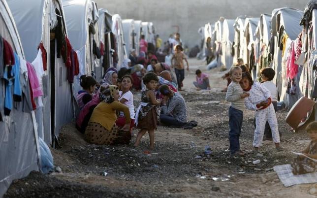 kurdish refugees from the syrian town of kobani sit in front of their tents in a camp in the southeastern town of suruc sanliurfa province photo reuters