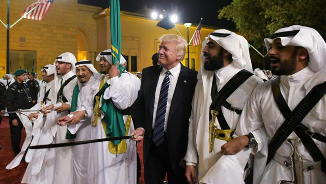 us president donald trump joins dancers with swords at a welcome ceremony ahead of a banquet at the murabba palace in riyadh photo afp