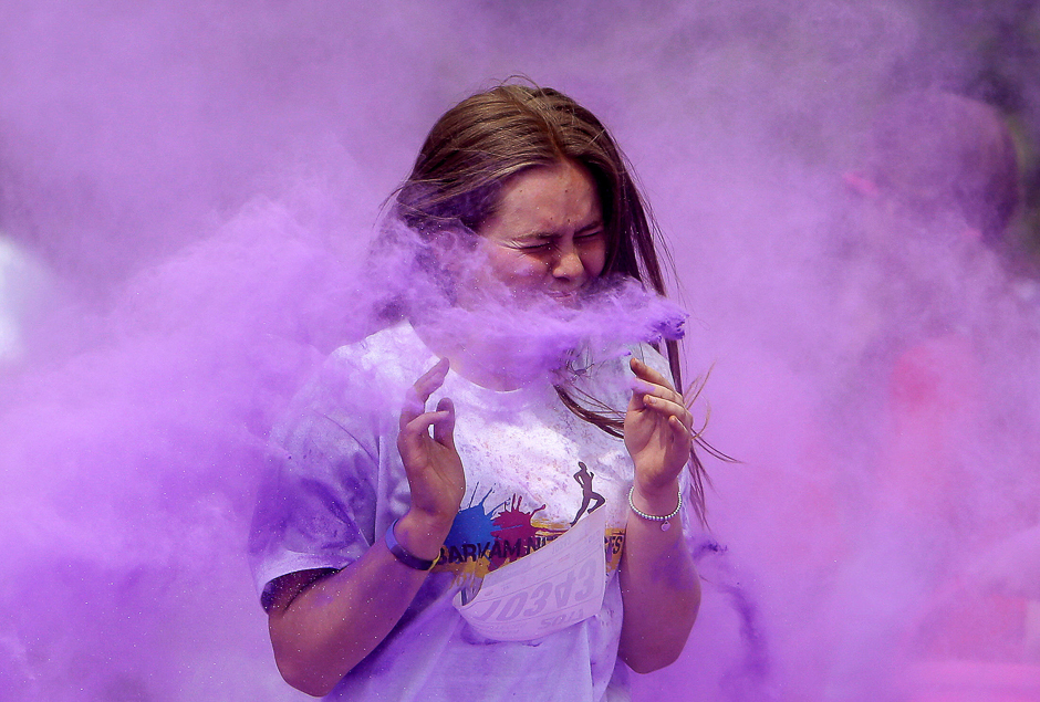 a participant runs through coloured powder as she takes part in the get rainbowed run in prague czech republic photo reuters