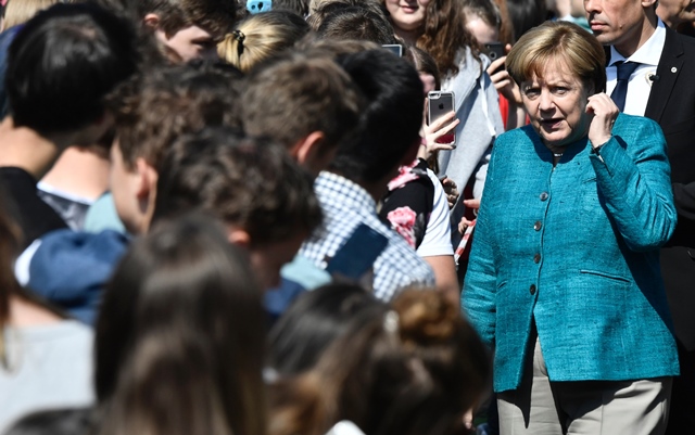 german chancellor angela merkel greets students as she arrives at the kurt tucholsky high school in berlin on may 22 2017 photo afp