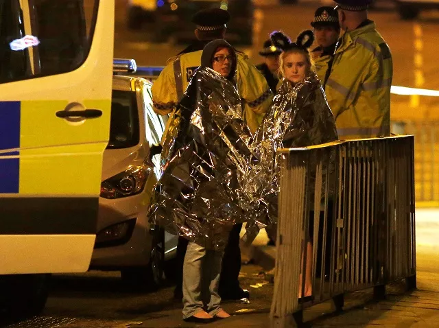 two women wrapped in thermal blankets stand near the manchester arena where us singer ariana grande had been performing in manchester northern england britain may 23 2017 two women wrapped in thermal blankets stand near the manchester arena where us singer ariana grande had been performing in manchester northern england britain may 23 2017