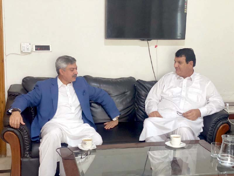 former governor s son farhan zafar jhagra meets pml n k p president amir muqam at his residence in islamabad photo express