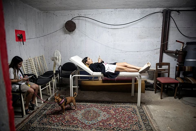 Israelis take cover in a bomb shelter as rockets are launched from the Gaza Strip, in Rishon Lezion, Israel October 7, 2023. REUTERS