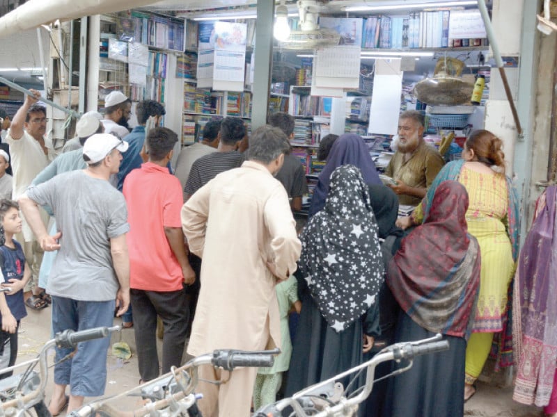 people stand at a bookshop in urdu bazaar on wednesday new textbooks for grades ix and x for karachi board are not available in the market photo express