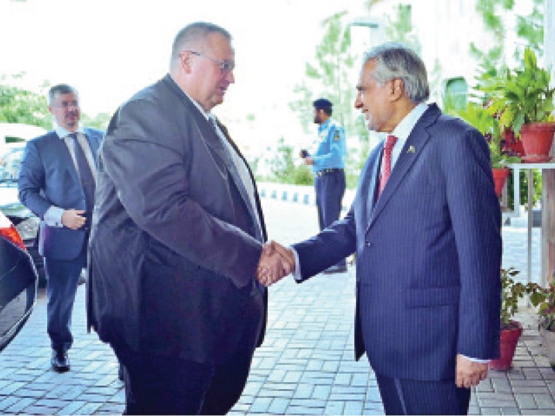 russian deputy prime minister alexei overchuk is welcomed by deputy prime minister ishaq dar upon arrival at the foreign ministry photo nni