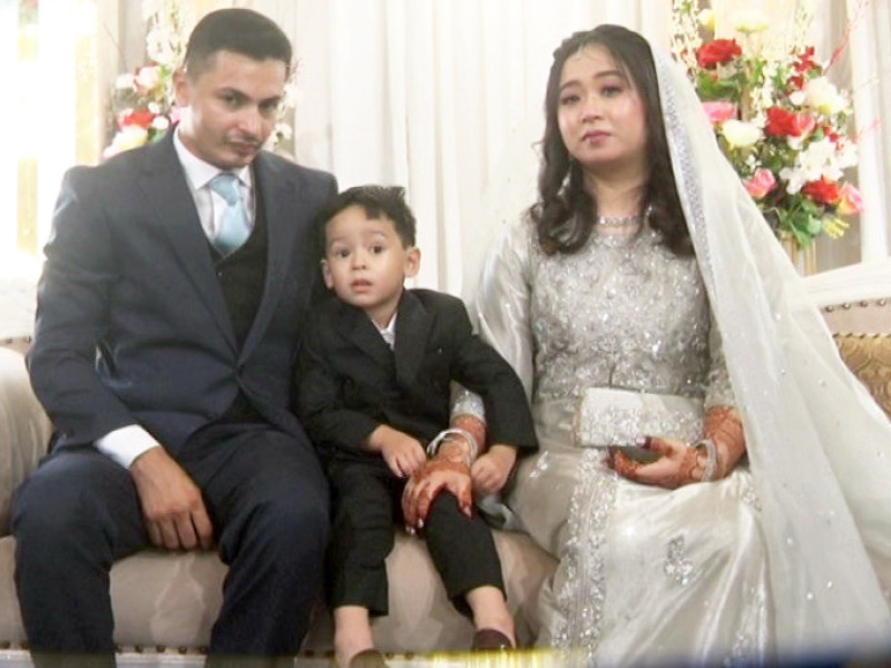 japanese bride hanifa hozmi yoshino sits with her groom tahir mohammad mamdani and son zain mamdani photo express