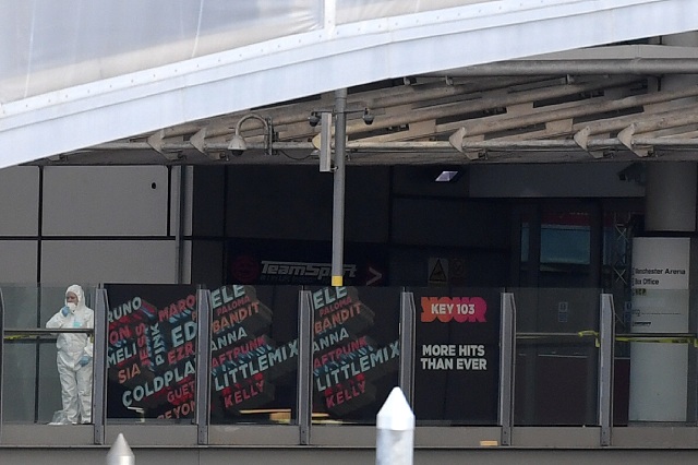 a police forensic officer stands by one of the entrances to the manchester arena scene of a terror attack during a pop concert by us star ariana grande in manchester northwest england on may 23 2017 nineteen people have been killed and dozens injured in britain 039 s deadliest teror attack in over a decade photo afp