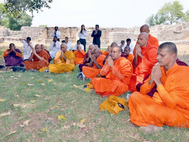 buddhist monks visit their holy sites at taxila photo agencies