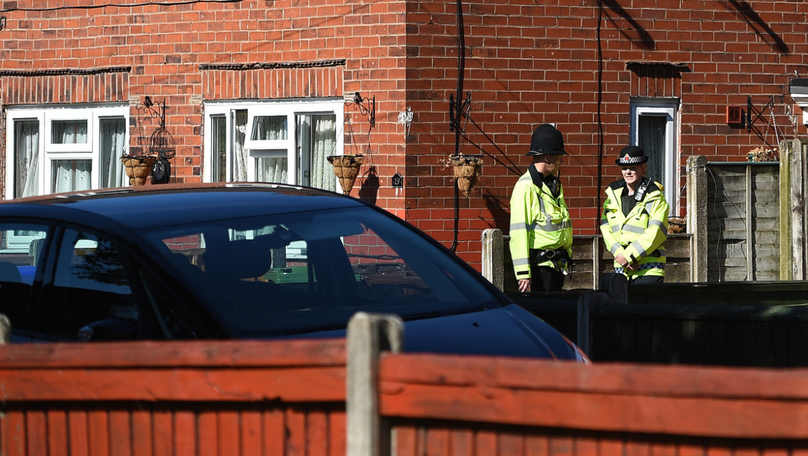 police officers stand on duty outside a house r in fallowfield manchester in northwest england on may 23 2017 photo afp