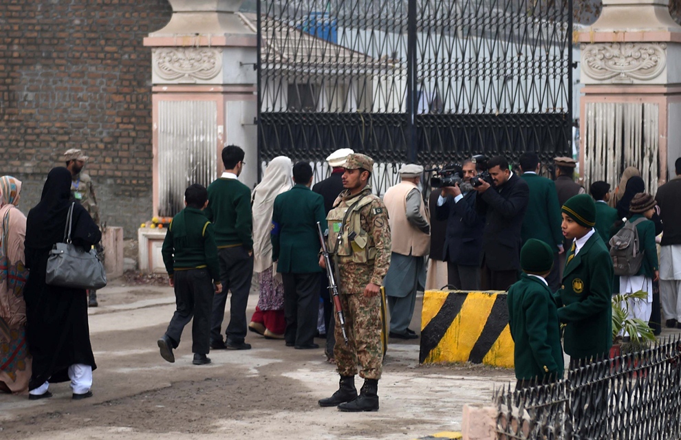 soldiers stand guard as parents arrive with their children at the army public school in peshawar on january 12 2015 photo afp file