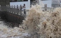 typhoon hits china weakens to tropical storm