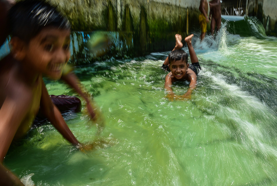 bangladeshi youths play in a pool amid rising temperatures in dhaka photo afp