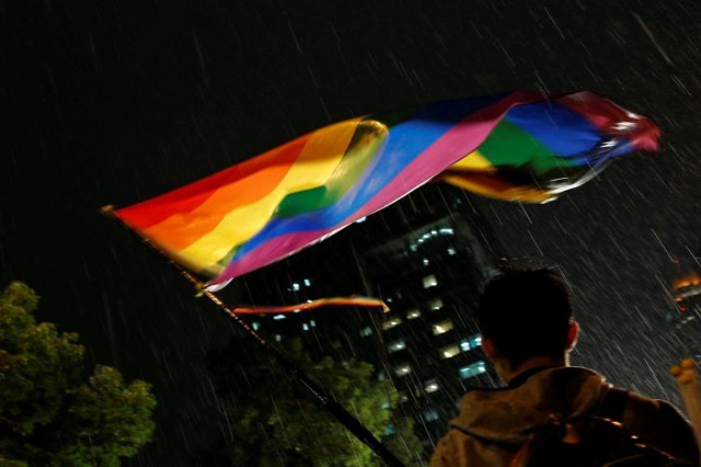 a supporter waves a rainbow flag during a rally after taiwan 039 s constitutional court ruled that same sex couples have the right to legally marry the first such ruling in asia in taipei taiwan may 24 2017 photo reuters