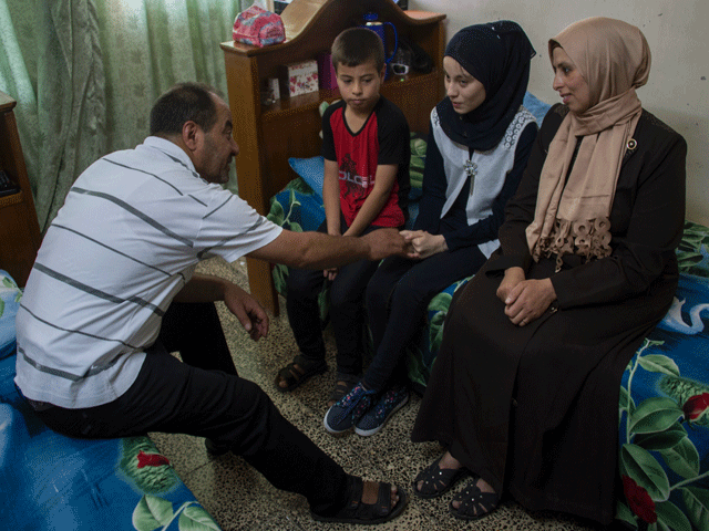 nour al ta 039 i c a 15 year old blind resident of east mosul and participant in quot al ghad star quot a radio talent contest organised by the al ghad studio based in the city of erbil sits in her room with her family at their home in mosul on may 18 2017 photo afp