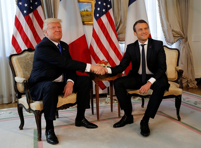 u s president donald trump l and french president emmanuel macron shake hands before a lunch ahead of a nato summit in brussels belgium may 25 2017 photo reuters