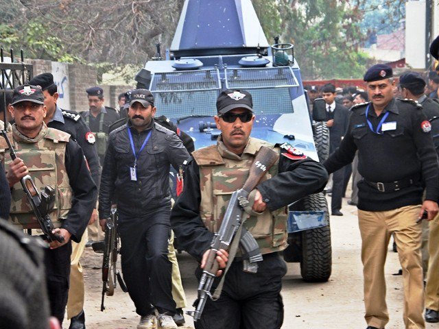 policemen escort an armoured vehicle in lahore on february 11 2011 photo afp file