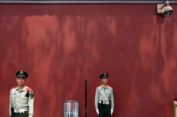 paramilitary police officers stand underneath a security camera near beijing 039 s tiananmen square china may 19 2017 photo reuters