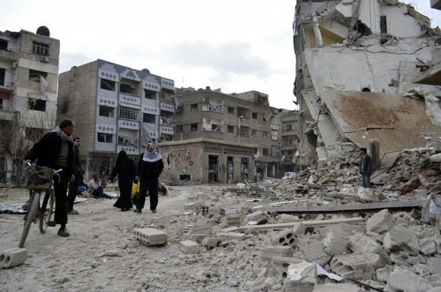 residents walk past damaged buildings after what activists said were air strikes by forces loyal to syria 039 s president bashar al assad in the douma neighborhood of damascus photo reuters residents walk past damaged buildings after what activists said were air strikes by forces loyal to syria 039 s president bashar al assad in the douma neighborhood of damascus photo reuters