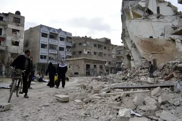 residents walk past damaged buildings after what activists said were air strikes by forces loyal to syria 039 s president bashar al assad in the douma neighborhood of damascus photo reuters residents walk past damaged buildings after what activists said were air strikes by forces loyal to syria 039 s president bashar al assad in the douma neighborhood of damascus photo reuters