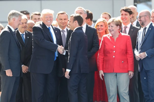 french president emmanuel macron 3rd r shakes hand with us president donald trump 2nd l as first row from l king philippe filip of belgium german chancellor angela merkel belgian prime minister charles michel look on during the unveiling ceremony of the berlin wall monument during the nato north atlantic treaty organization summit at the nato headquarters in brussels photo afp french president emmanuel macron 3rd r shakes hand with us president donald trump 2nd l as first row from l king philippe filip of belgium german chancellor angela merkel belgian prime minister charles michel look on during the unveiling ceremony of the berlin wall monument during the nato north atlantic treaty organization summit at the nato headquarters in brussels photo afp