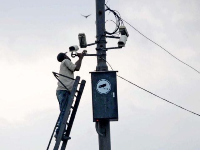 a man installing cctv camera photo file