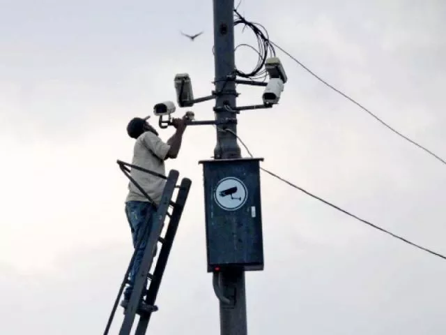 a man installing cctv camera photo file a man installing cctv camera photo file