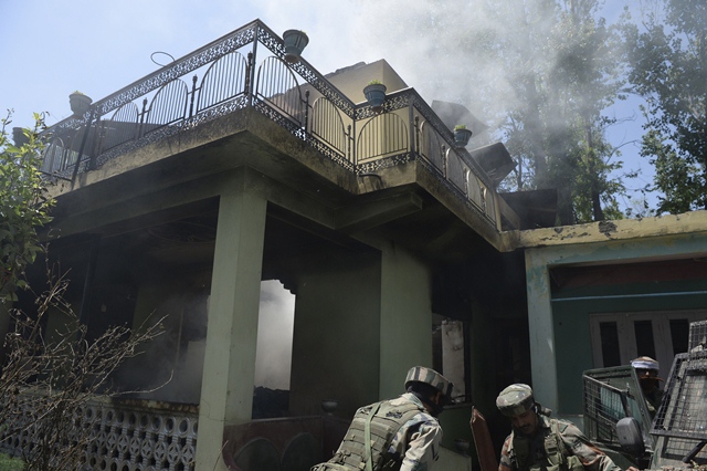 indian army soldiers stand next to a burning house where two kashmiri 039 rebels 039 were killed during a gunfight in the tral area south of srinagar photo afp