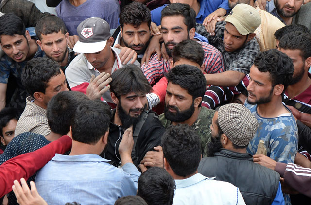 a kashmiri rebel centre wearing black mourns during the funeral of rebel commander sabzar ahmad bhat in rathsuna tral near srinagar on may 28 2017 authorities imposed a curfew in many parts of the main srinagar city as violence spread across the restive region after sabzar ahmad bhat 039 s death on may 27 bhat head of the hizbul mujahideen militant group was killed in a gunfight with government forces in tral area some 40 kilometres south of srinagar photo afp