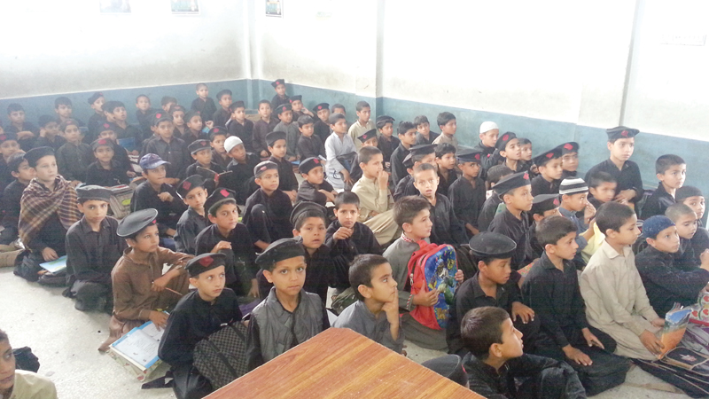 as many as 130 students are crammed in a classroom in the school without any desks to sit at photo express