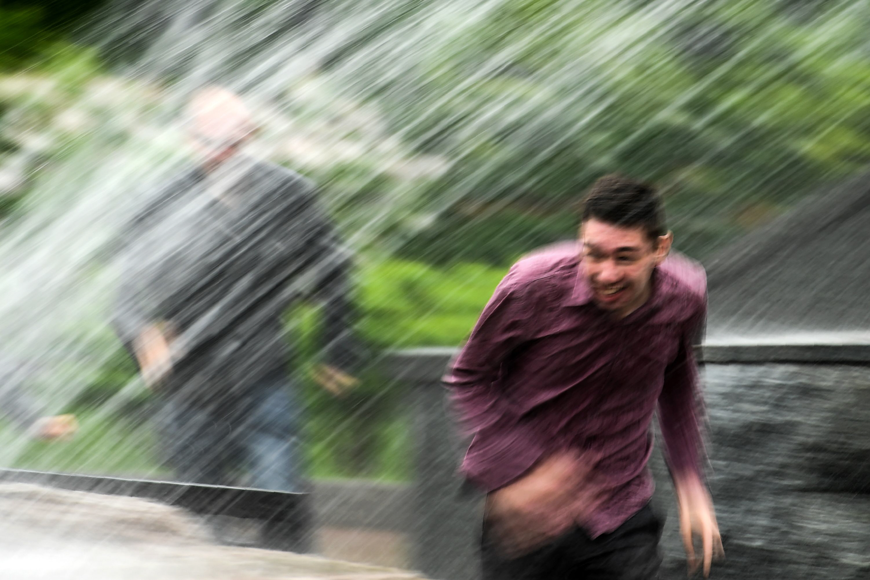 a man runs through heavy rain in moscow 039 s alexander garden on may 29 2017 photo afp