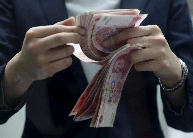 a clerk counts chinese 100 yuan banknotes at a branch of a foreign bank in beijing january 4 2016 photo reuters a clerk counts chinese 100 yuan banknotes at a branch of a foreign bank in beijing january 4 2016 photo reuters