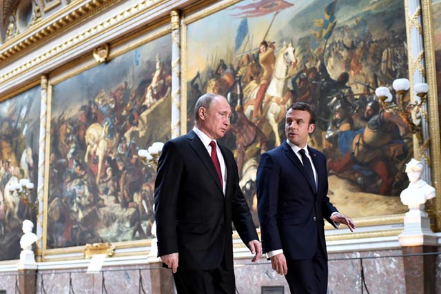 french president emmanuel macron r speaks to russian president vladimir putin l in the galerie des batailles gallery of battles as they arrive for a joint press conference at the chateau de versailles before the opening of an exhibition marking 300 years of diplomatic ties between the two countries in versailles france may 29 2017 photo reuters