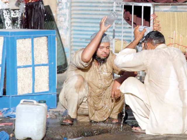 labourers taking a bath outside a shop at shoba bazaar to get relief from the scorching hot day in peshawar photo app labourers taking a bath outside a shop at shoba bazaar to get relief from the scorching hot day in peshawar photo app