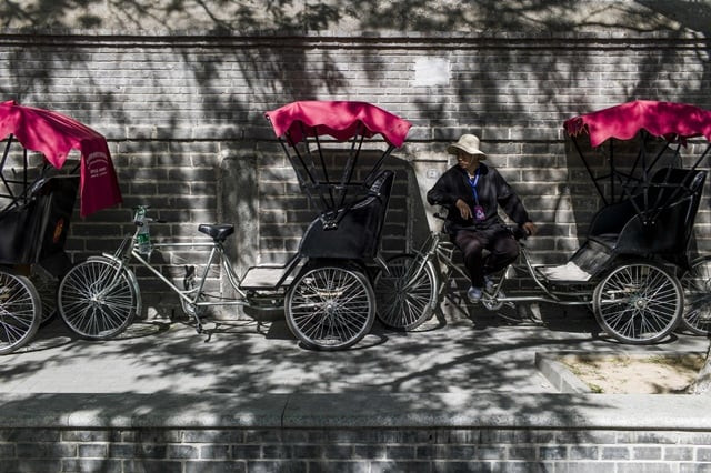 this photo taken on april 24 2017 shows a rickshaw driver waiting for customers in a touristic area in beijing appearing in china at the end of the 19th century rickshaws originally had two wheels and were pulled by their driver on foot with passengers seated at the back today most of the vehicles are tricycles some still have pedals and are propelled by physical force but the majority are equipped with electric or gas engines photo afp this photo taken on april 24 2017 shows a rickshaw driver waiting for customers in a touristic area in beijing appearing in china at the end of the 19th century rickshaws originally had two wheels and were pulled by their driver on foot with passengers seated at the back today most of the vehicles are tricycles some still have pedals and are propelled by physical force but the majority are equipped with electric or gas engines photo afp