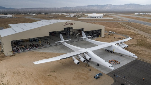 the stratolaunch plane is pushed out of the hanger for the first time in the mojave desert california photo afp