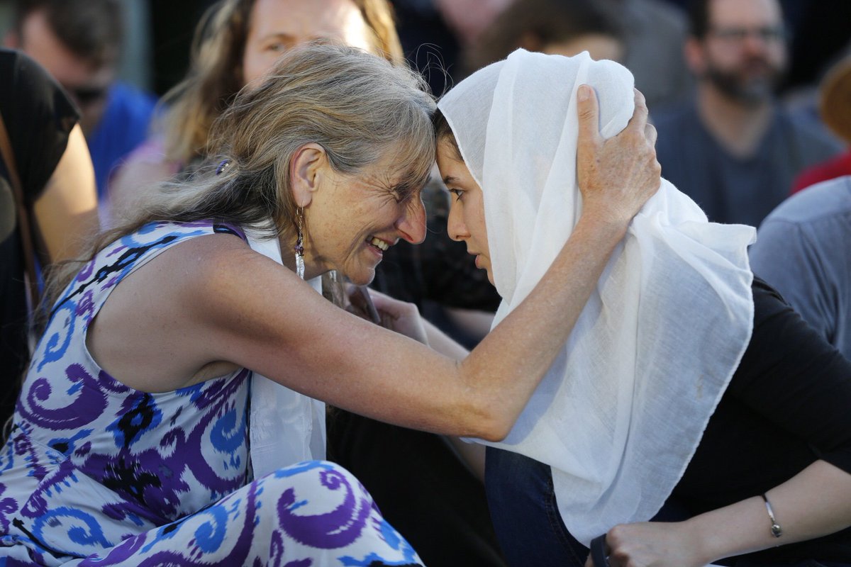 mother of one of the victims asha deliverance is pictured at a vigil photo twitter