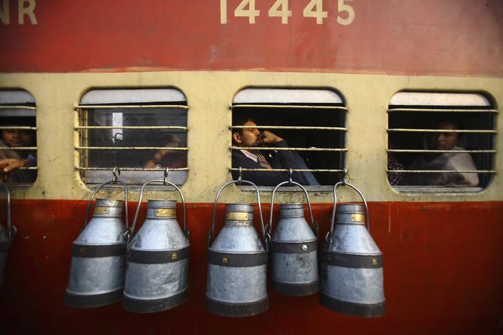 empty milk containers hang from the window of a train in uttar pradesh november 10 2012 photo reuters